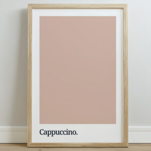 A framed print featuring a cappuccino-colored swatch above the word "Cappuccino." in a modern, sans-serif font, set against a white background.