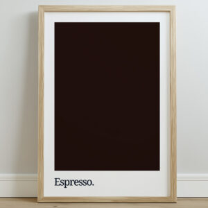 A framed print featuring a dark brown background with the word "Espresso." in white typography at the bottom, displayed against a light wall and wooden floor.