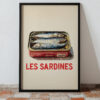A framed poster featuring a tin of sardines with the text "LES SARDINES" in bold red letters.